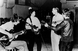 Publicity photo of the Beatles with producer George Martin in the studio at Abbey Road in 1966. Only John Lennon, George Harrison and Paul McCartney are pictured. Capitol Records