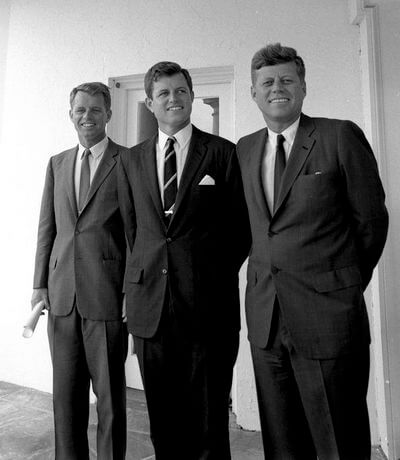 President John F. Kennedy poses with his brothers in the West Wing Colonnade outside the Oval Office, White House, Washington, D.C. (L-R) Attorney General Robert F. Kennedy; Senator Edward M. Kennedy (Massachusetts); President Kennedy.
