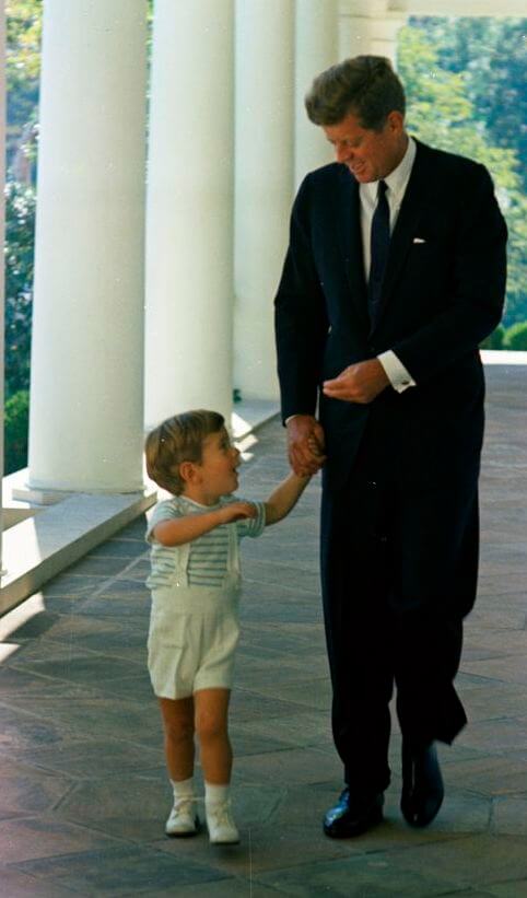Photographer: Stoughton, Cecil W. (Cecil William), 1920-2008 Description: President John F. Kennedy walks with his son, John F. Kennedy, Jr., along the West Wing Colonnade of the White House, Washington
